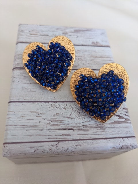 Gold metal heart shaped earrings colombian